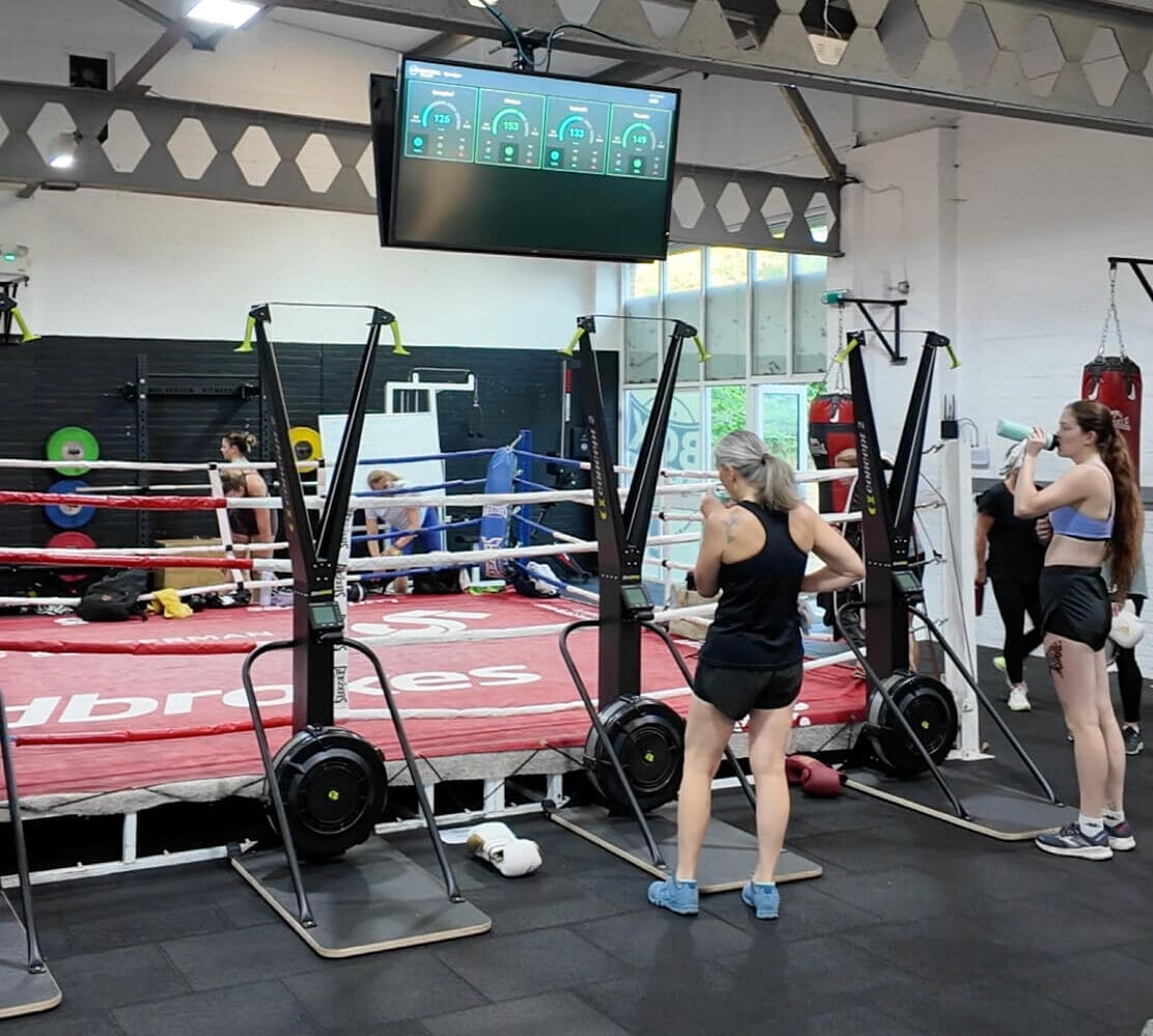 group of women standing around a boxing ring